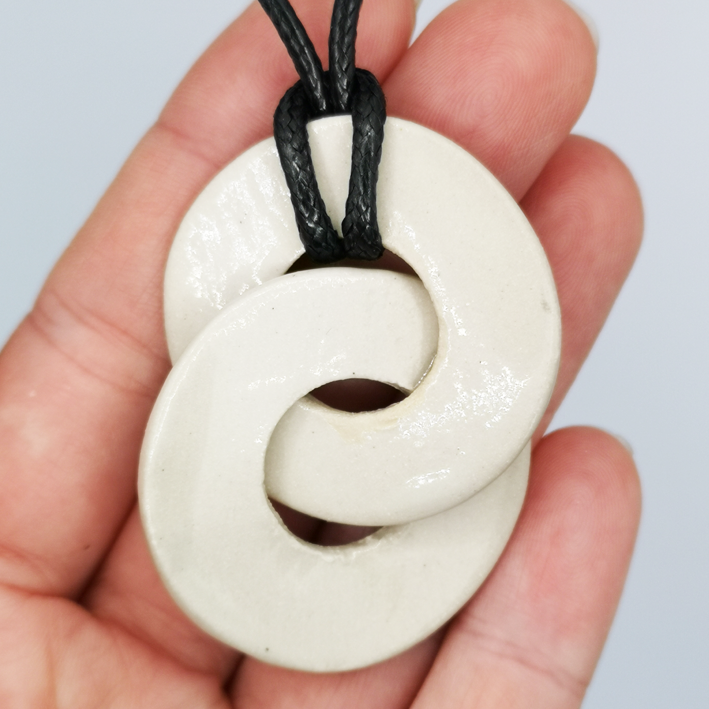Collier de luxe avec pendentif Loop Infini en argile blanche, réglable en longueur grâce à un nœud coulissant
